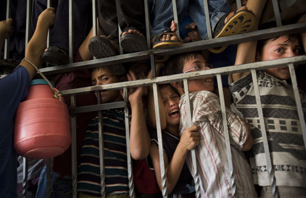 24 hours in pictures: Palestinian children during a struggle to get a ration of donated food 