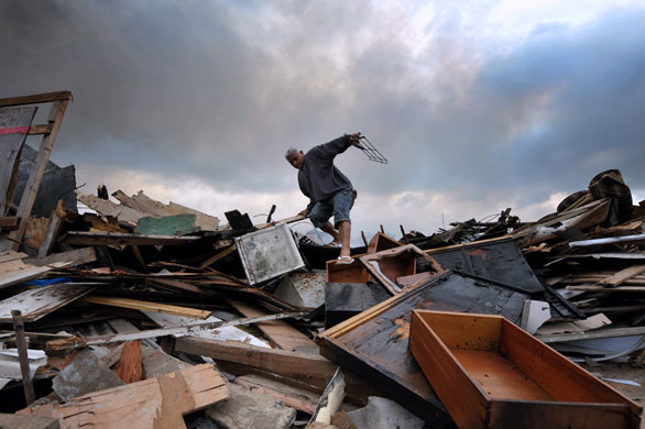 24 hours in pictures: A resident amid rubble during an eviction at Capao Redondo shantytown