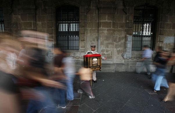 24 hours in pictures: A traditional organillero performs in Mexico's city main square