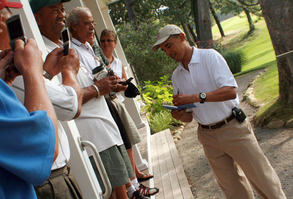 Obama on vacation: Barack Obama signs autographs as he arrives at the Mink Meadows Golf Course
