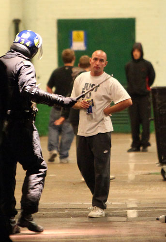 west ham millwall: A man confronts riot police outside Upton Park