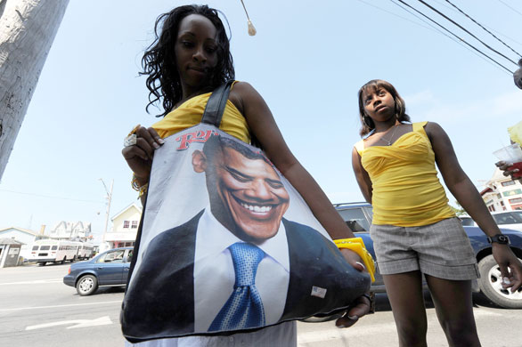 Obama vacation: A tourist walks around with a bag adorned with a picture of Barack Obama