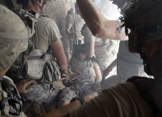 26 August 2009: Bargematal, Afghanistan: A US soldier, wounded by sniper fire