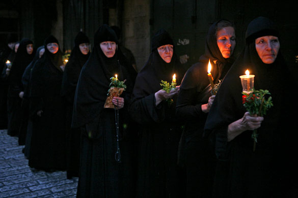 26 August 2009: Jerusalem: Christian Orthodox nuns holding candles and flowers