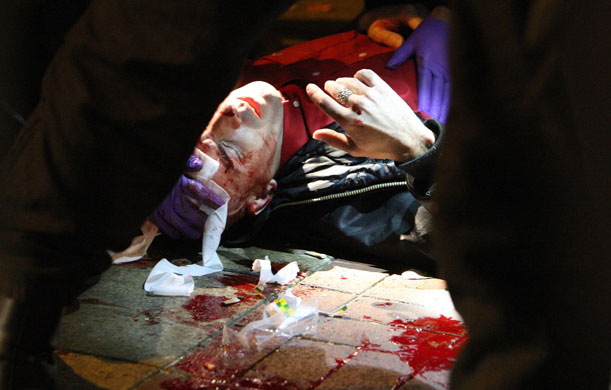 26 August 2009: London, UK: Police medics attend to an injured man