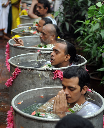 26 August 2009: Mumbai, India: Hindu holy men chant mantras and pray