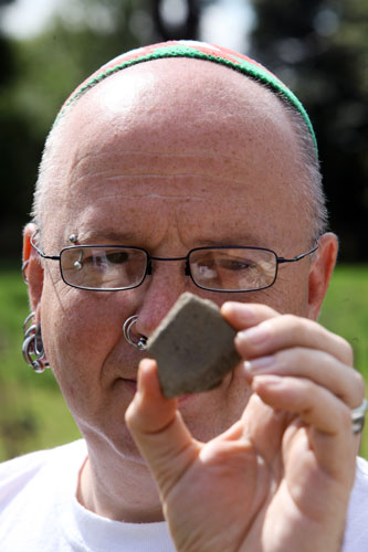 Summer digs: Keith Fitzpatrick-Matthews l looking at a piece of pottery