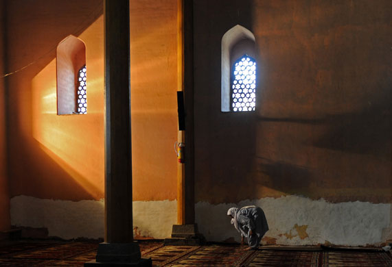 24 hours in pictures: Srinagar, India: A Kashmiri Muslim woman prays in Kashmir's grand mosque.