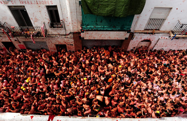 24 hours in pictures: Bunol, Spain: Revellers pelt each other with tomatoes during a tomato fight