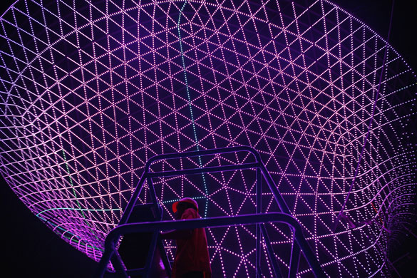 24 hours in pictures: Shanghai, China: A worker trial-runs lights at the Shanghai Expo