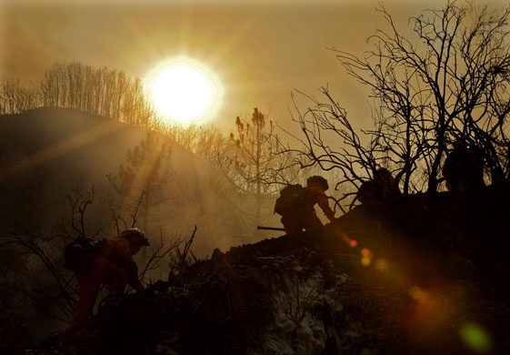 24 hours in pictures: California, US: Camp crew firefighters climb a ridge during a forest fire