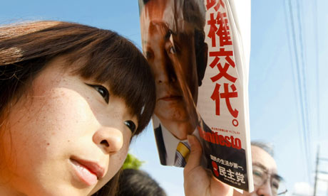 A woman listens to Japan's main opposition Democratic party of Japan leader Yukio Hatoyama