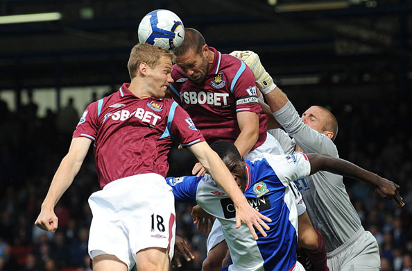 premier league: Matthew Upson and Jonathan Spector head the ball clear