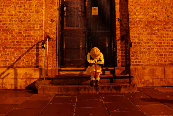 I see, you don't see: A lone figure crouches on some steps