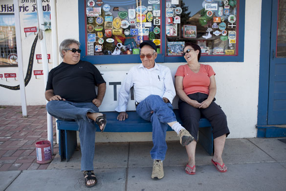 Route 66 Day 4: People sit on a banch on old Route 66, Seligman, Arizona