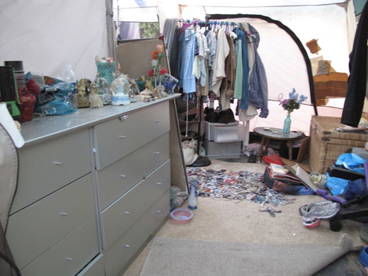 Jaycee Dugard kidnapping: Clothes hanging on a rail in front of taped repairs to the tent