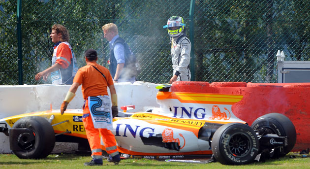 Belgian Grand Prix: Brawn GP's British driver Jenson Button looks at Renault's crashed car