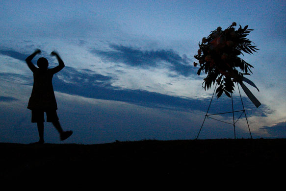 24 hours in pictures: New Orleans, US: Children dance atop a levee in New Orleans East