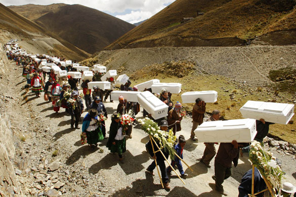 24 hours in pictures: Putis, Peru: Coffins of victims killed in a massacre in 1984 