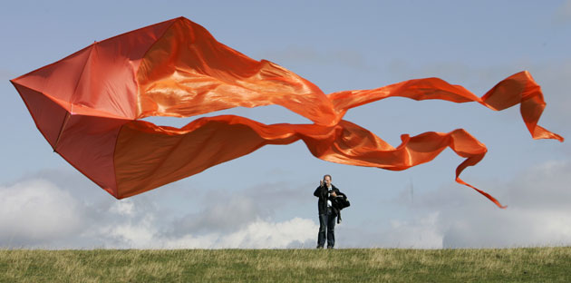 24 hours in pictures: Brunsbuettel, Germany: A man takes a photo of a kite 