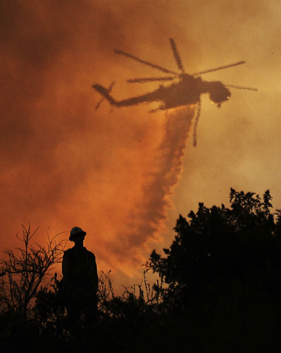 24 hours in pictures: La Canada Flintridge, US: A firefighter watches a water drop