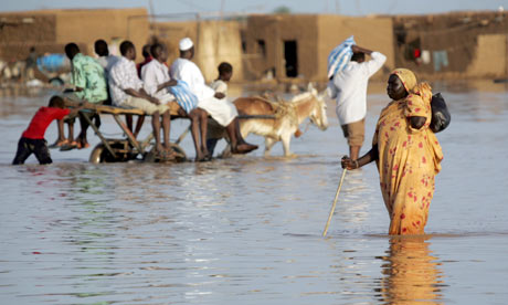 A Sudanese woman walks through a flooded road following heavy rain in southern Khartoum.