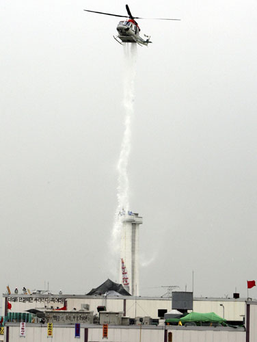 Ssonyang motors seige: A police helicopter drops tear-gas on Ssangyong Motor plantin Korea 