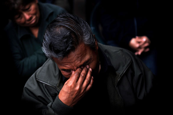 24 hours in pictures : relatives of shining path attack casualty in peru 