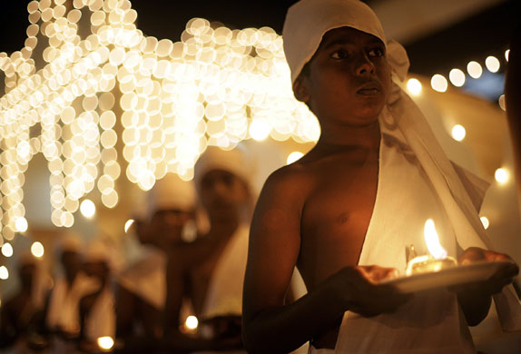 5 August 2009: Kandy, Sri Lanka: Children hold lamps in front of the Sri Dalada Maligawa