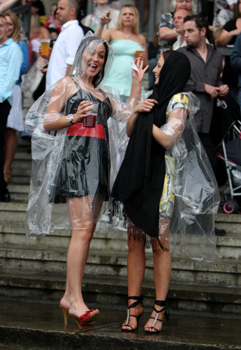7 August 2009: Sandown, UK: Racegoers enjoy the racing despite the inclement weather