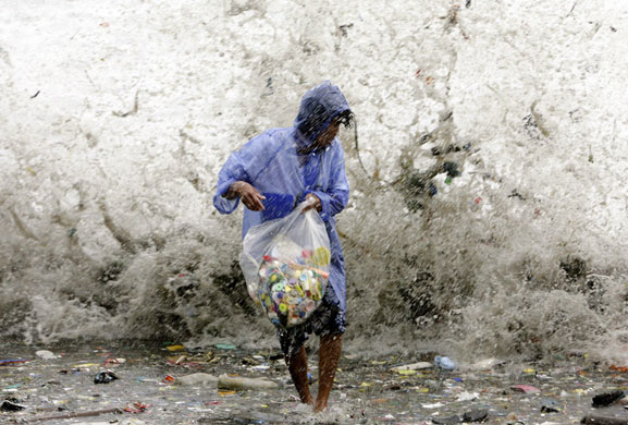 7 August 2009: Manila, Philippines: A woman is hit by waves