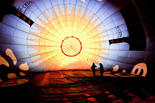 Bristol balloon festival: Two people inside a colourful hot air balloon