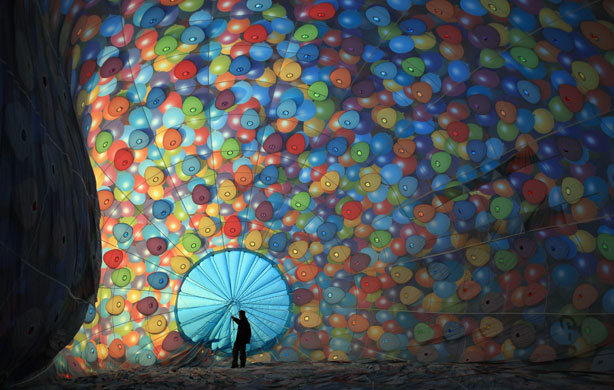 Bristol balloon festival: A man checks ropes inside his balloon