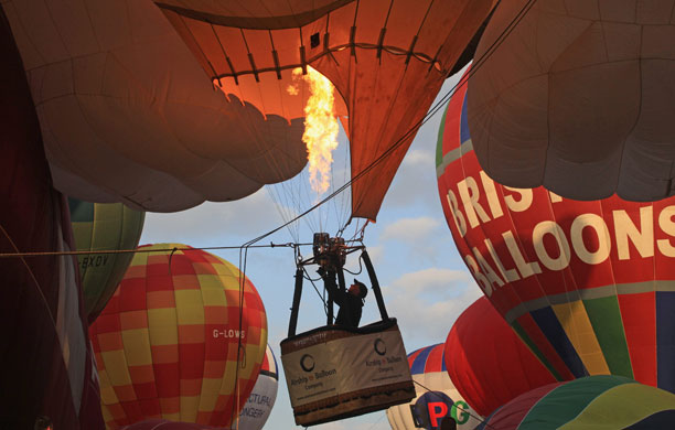 Bristol balloon festival: A balloonist fires his burners as he prepares to take-off