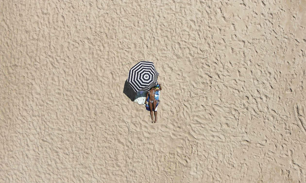 24 hours : Woman sunbathes on a beach of Pinheiro da Cruz