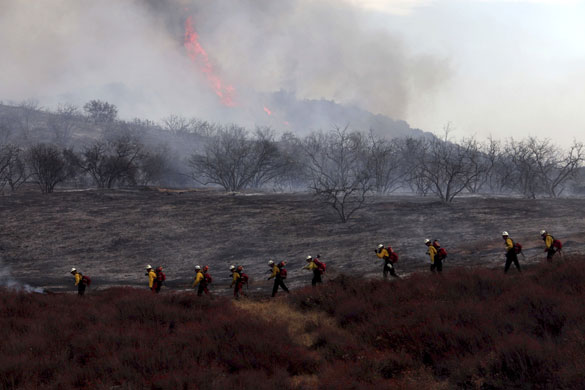 California wildfires: Fire crews walk near a wildfire in Oak Glen in San Bernardino county