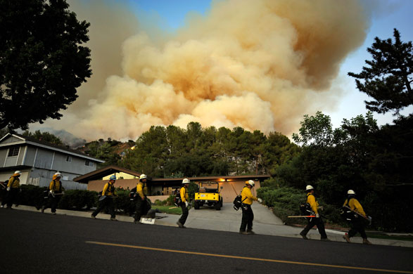 California wildfires: A Forest Service hand crew walk down a street in La Crescenta