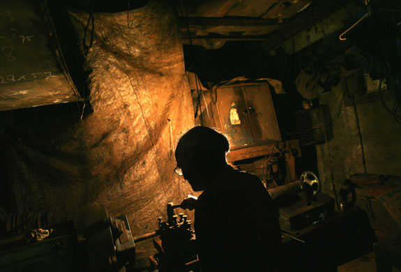 1 September 2009: Mumbai, India: A labourer works in a metal workshop