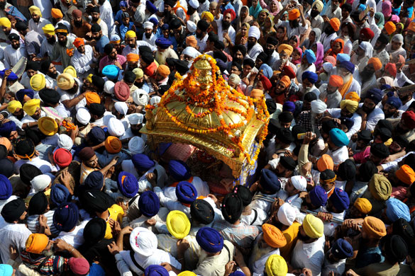 1 September 2009: Amritsar, India: Sikh devotees carry the Palki Sahib (Sikh Holy Book)