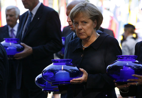 ww II anniversary: German Chancellor Merkel carries a candle in Gdansk