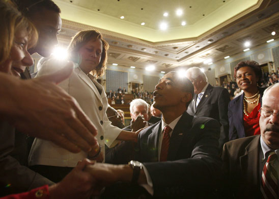 Barack Obama healthcare: Barack Obama greets people in the House chamber