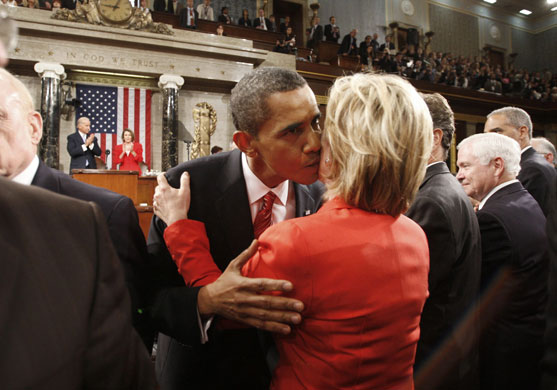 Barack Obama healthcare: Barack Obama kisses Hillary Rodham Clinton as he leaves the floor of House