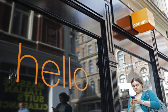 Week in Business: A woman walks by an Orange mobile phone shop in the City of London. 