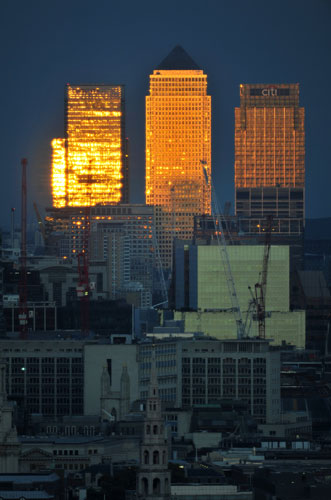 Week in Business: The setting sun is reflected in London's Canary Wharf. 