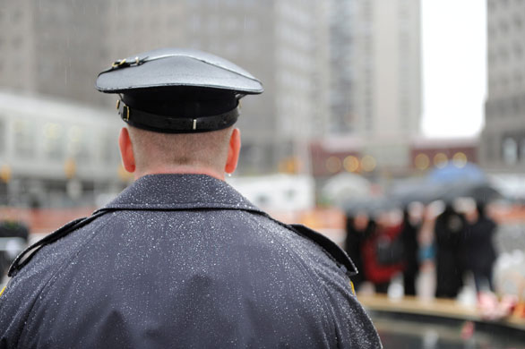 9/11 anniversary : A police officer stands as relatives and friends visit the reflecting pool 