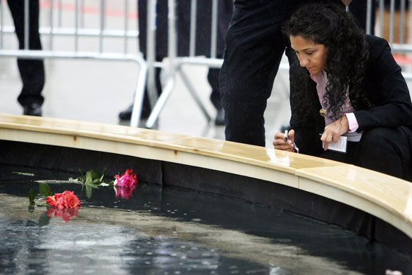 9/11 anniversary : People visit the reflecting pool during the 9/11 anniversary commemoration