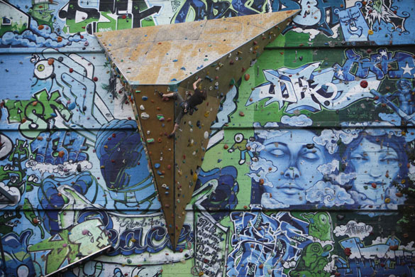 24 hours in pictures: Hamburg, Germany: A man climbs on the wall during a festival