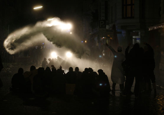 24 hours in pictures: Hamburg, Germany: A group of demonstrators is hit by a water cannon