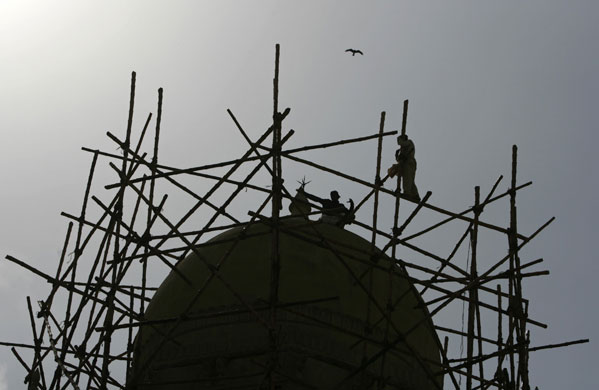 24 hours in pictures: Construction workers set a bamboo scaffolding in Karachi