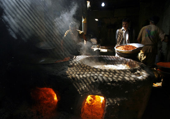 24 hours in pictures: Kabul, Afghanistan: A man prepares seemian, a traditional Afghan sweet